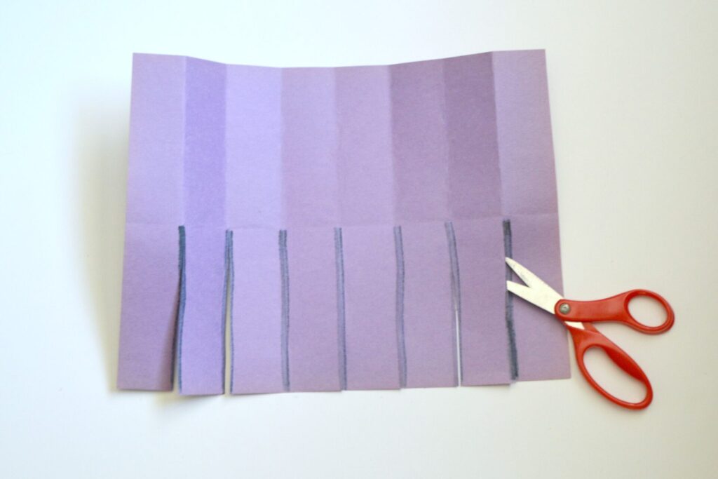 photo of folded paper with cut lines cut with scissors