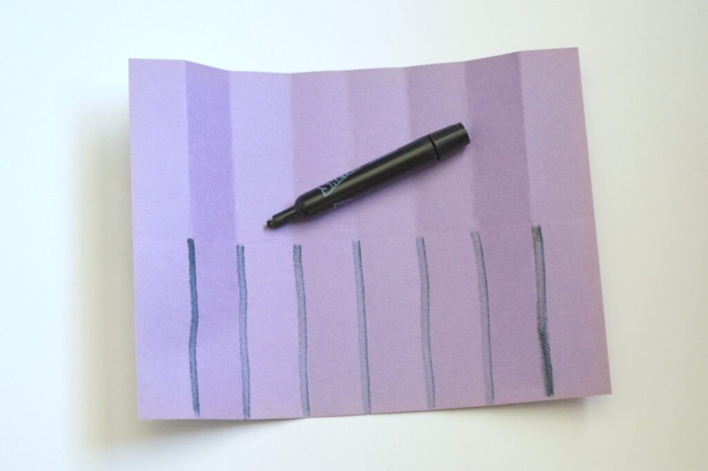 Photo of folded paper with cut lines drawn with a marker